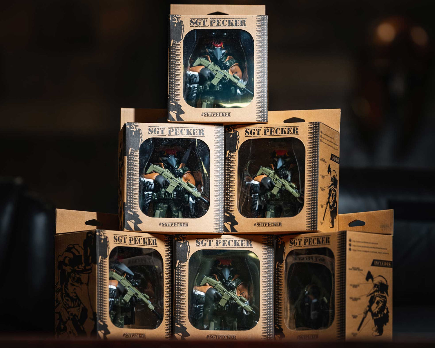 SGT Pecker Action figures inside packaging stacked up on top of each other.